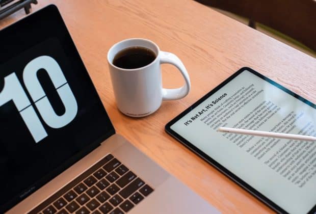 a tablet and a cup of coffee on a table