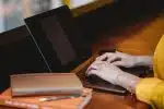 person using black laptop computer